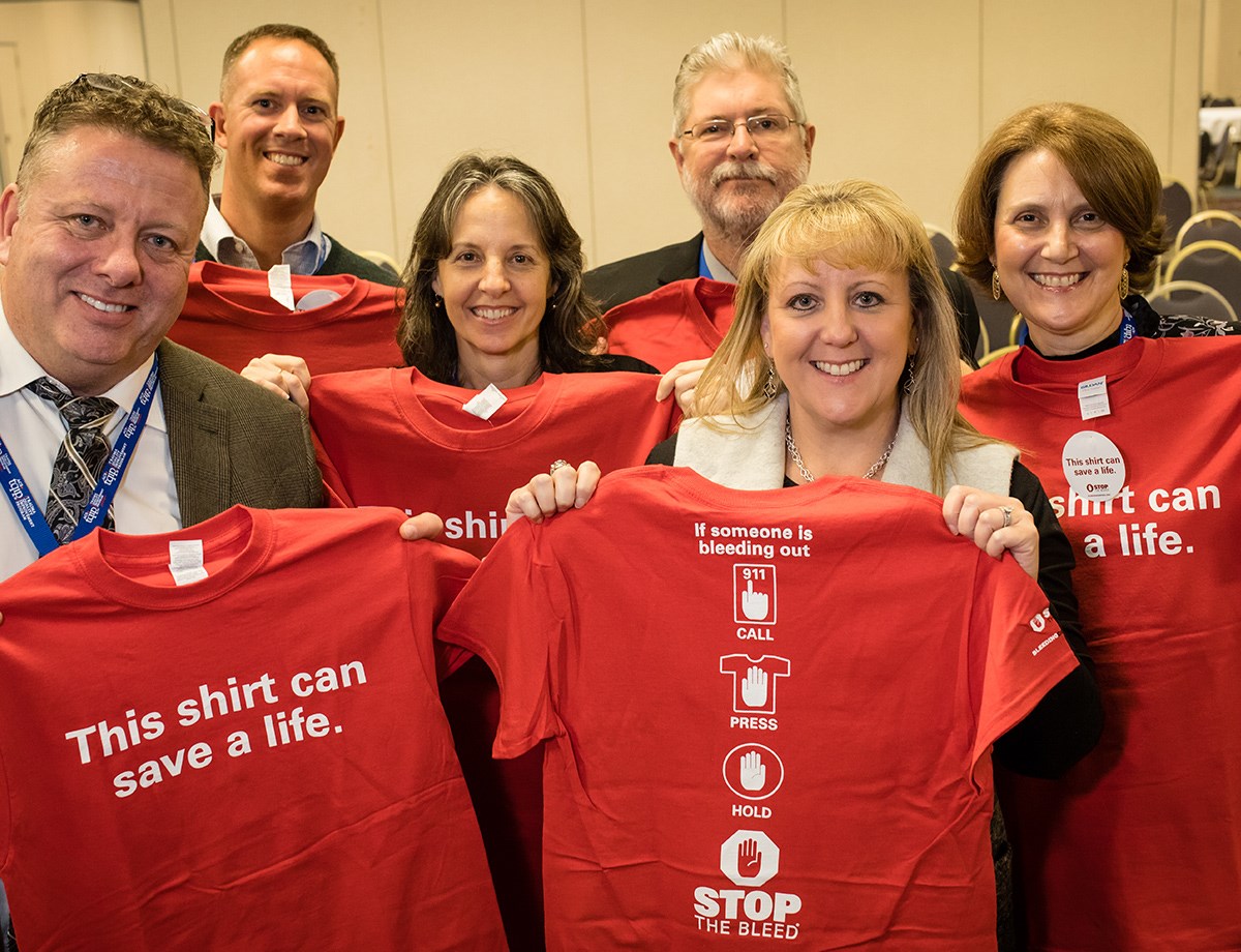 2015 group photo showing red STOP THE BLEED t-shirts 